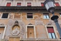 Rome, Italy: Aged, textured wall with variety of frames and windows. Old building exterior with cracked paint.