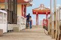 Aged Thai couple takes a selfie on a Chinese-style decorated pier