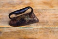 Aged vintage clothes iron in rusted metal