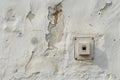 Aged wall with peeling paint and light switch Royalty Free Stock Photo
