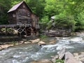 Aged water mill on a stony riverbank as the waters of a stream flow past