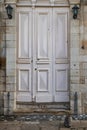 Aged and whiteish wooden doors with lights