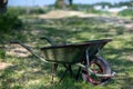 a old wheelbarrow and wooden wheel barrow are pictured outside