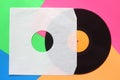 Aged white paper cover and black vinyl LP record isolated on colorful background Royalty Free Stock Photo