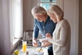 Aged wife and husband preparing healthy food in the kitchen Royalty Free Stock Photo