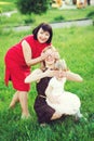 Aged woman with adult daughter and little granddaughter have fun toghether outdoor, close eyes to each other.