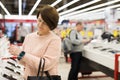 Aged woman choosing digital wristwatches in electronic store Royalty Free Stock Photo