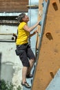 Aged Woman Climbing Wall Royalty Free Stock Photo