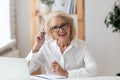 Aged businesswoman interviewing applicant during distant job interview using laptop