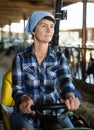 Aged woman on farm tractor Royalty Free Stock Photo