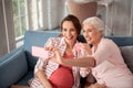 Aged woman feeling memorable making photo with her niece
