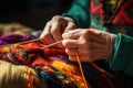 An aged woman grandmother knits with knitting needles