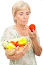 Aged woman holding vegetables Royalty Free Stock Photo