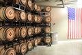 Aged wood barrels stacked on metal shelving units, Black Button Distillery, Rochester, New York, 2017