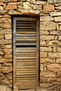 Aged wood door on masonry stone wall Royalty Free Stock Photo