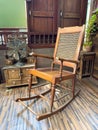 Aged wooden armchair surrounded by vintage cabinets, lending an atmosphere of antique charm