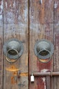 Aged wooden door with knocker and lock Royalty Free Stock Photo