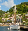 An old island ferry used for tourist excursions tied to a dock in the windward islands