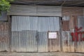 aged, worn old garage door on dilapidated urban building