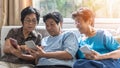 Ageing society concept with Asian elderly senior adult women sisters using mobile digital smart phone application technology
