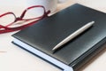 Agenda, pen and glasses on a wooden table. Royalty Free Stock Photo