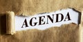 Agenda, text is written on torn brown paper. Royalty Free Stock Photo