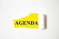 Agenda the text is written on a white background and a yellow piece of paper Royalty Free Stock Photo