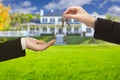 Agent Handing Over House Keys in Front of New Home Royalty Free Stock Photo