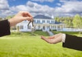 Agent Handing Over House Keys in Front of New Home Royalty Free Stock Photo