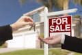 Agent Handing Over House Keys in Front of New Home Royalty Free Stock Photo