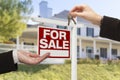 Agent Handing Over House Keys in Front of New Home