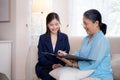 Agent insurance life or health or adviser young asian woman and elderly woman doing agreement and signature on document. Royalty Free Stock Photo