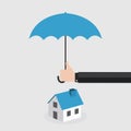 Agent's hand holding umbrella over house