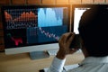 Agent trader man talking at telephone and checking business stock data on computer in office room