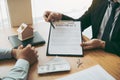 Agents are using pens pointing to insurance contracts and are being explained to customers at the office Royalty Free Stock Photo