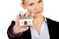 Aggresive business woman crushing small house Royalty Free Stock Photo