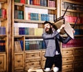 Aggression, hate, nervous, negative emotions concept. Man with angry face holds chair and ruins library. Bearded man in Royalty Free Stock Photo