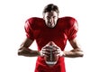 Aggressive American football player in red jersey holding ball Royalty Free Stock Photo