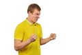 Aggressive angry man in yellow T-shirt ready to fight with fists isolated on white background Royalty Free Stock Photo