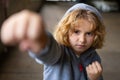 Aggressive bad child. Kid boy in hoodie fighting. Little kid boy fight outdoor. Angry boy fighting fist. Bad kids Royalty Free Stock Photo