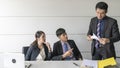 Aggressive boss businessman holding paper file work and complain staff and colleague in meeting conference room Royalty Free Stock Photo