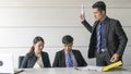 Aggressive boss businessman holding paper file work and complain staff and colleague in meeting conference room Royalty Free Stock Photo