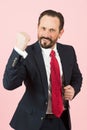 Aggressive businessman with beard wearing a blue suit and red tie fighting with angry expression. Angry man face emotion