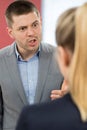 Aggressive Businessman Bullying Female Colleague In Office