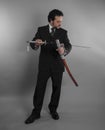 Aggressive businessman with Japanese swords in defensive and def Royalty Free Stock Photo