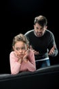 Aggressive father screaming at upset daughter on black Royalty Free Stock Photo