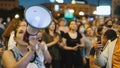 Aggressive female feminist speaks loudly with bullhorn megaphone in Russian.