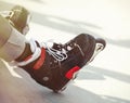 Aggressive inline rollerblader sitting on ramp in skatepark Royalty Free Stock Photo