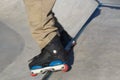 Aggressive inline skater grinds on rail coping in concrete pool. Roller blader doing grind trick in outdoor skaterpark. Extreme