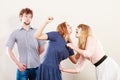 Aggressive mad women fighting over man. Royalty Free Stock Photo